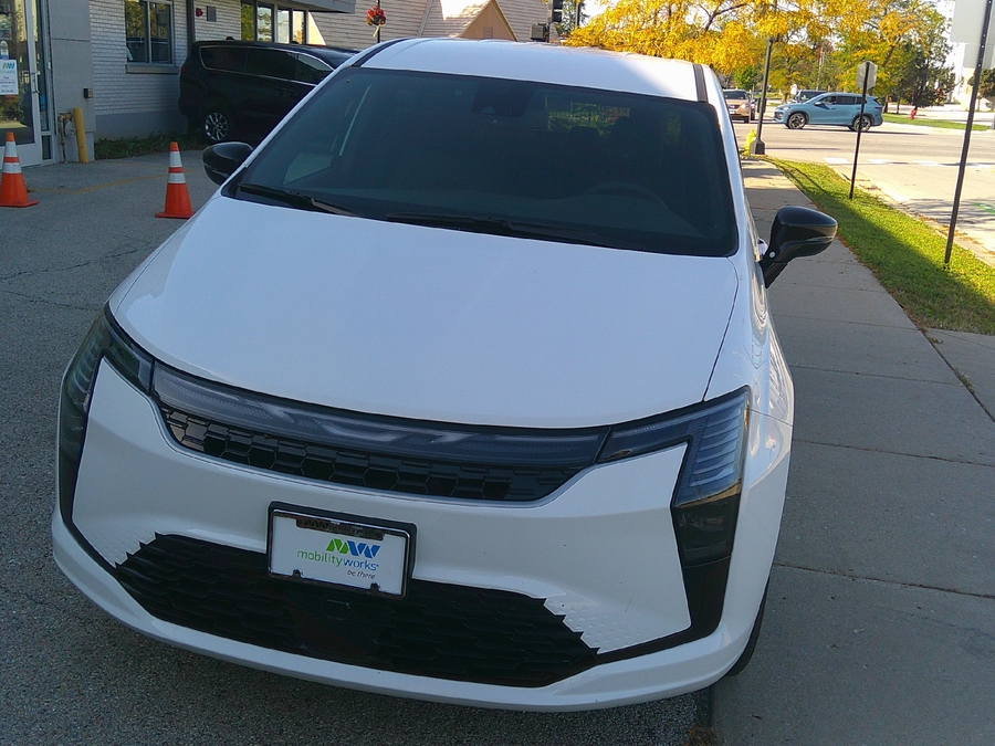 White Chrysler Pacifica with Driverge Side Entry Automatic Fold Out conversion
