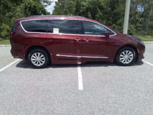Red Chrysler Pacifica with Adaptive Vans Side Entry Automatic Fold Out conversion