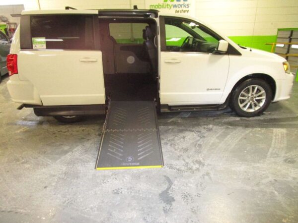 White Dodge Grand Caravan with Driverge Side Entry Automatic Fold Out conversion