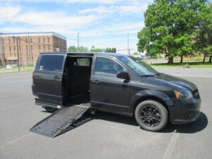 Red Dodge Grand Caravan with Adaptive Vans Side Entry Automatic Fold Out conversion