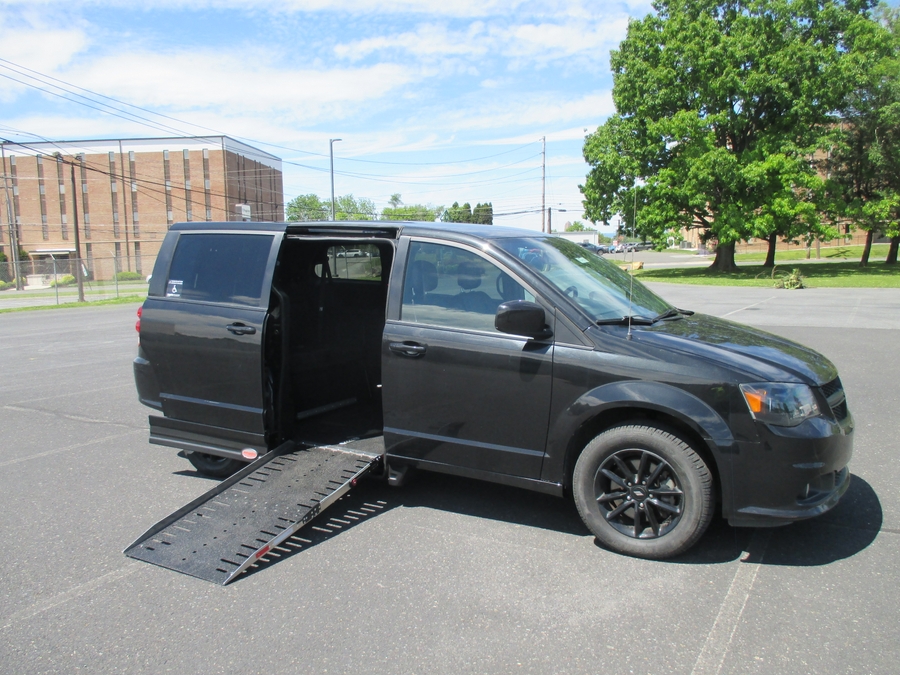 Red Dodge Grand Caravan with Adaptive Vans Side Entry Automatic Fold Out conversion