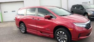 Red Honda Odyssey with BraunAbility Side Entry Automatic In Floor conversion