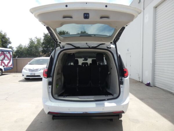 White Chrysler Pacifica with Driverge Side Entry Automatic Fold Out conversion