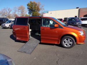 Orange Dodge Grand Caravan with Rollx Side Entry Automatic In Floor conversion