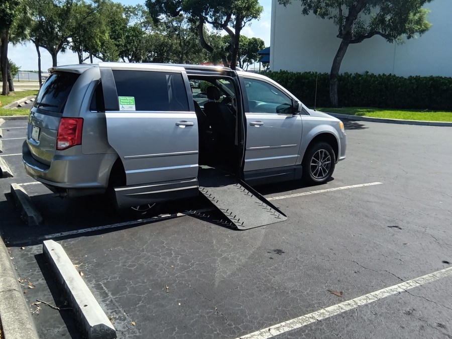 Silver Dodge Grand Caravan with Adaptive Vans Side Entry Automatic Fold Out conversion
