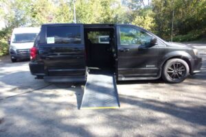 Black Dodge Grand Caravan with Driverge Side Entry Automatic Fold Out conversion