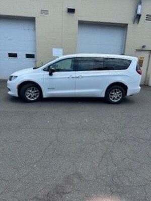 White Chrysler Voyager with Driverge Rear Entry Manual Fold Out conversion