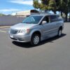 Silver Chrysler Town and Country with BraunAbility Side Entry Automatic Fold Out conversion