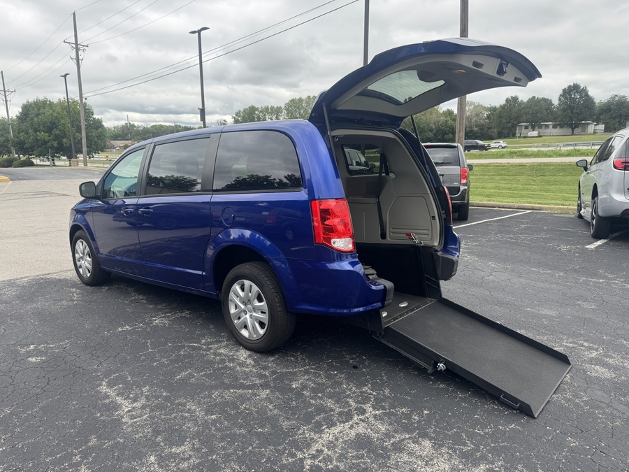 Blue Dodge Grand Caravan with International Sales and Mobility Rear Entry Manual Fold Out conversion