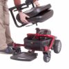 person removing seat from power wheelchair