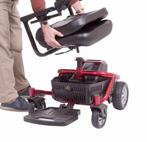 person removing seat from power wheelchair