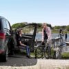 Man exiting vehicle with Turny Evo seat at a lake with girl with wheelchair