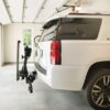 Out-sider lift on back of white suv inside garage