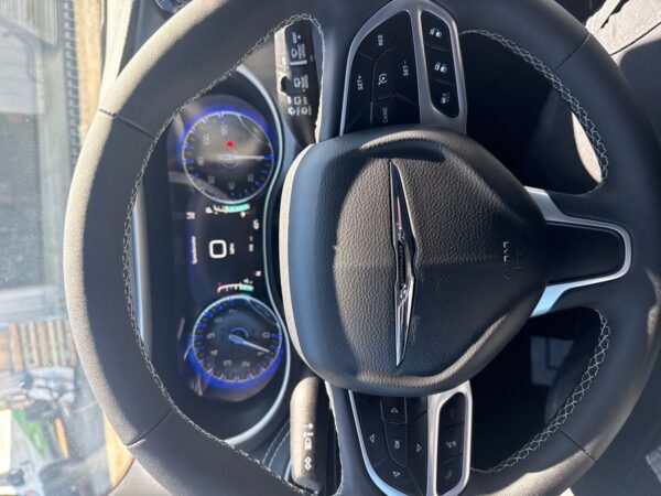 Silver Chrysler Pacifica with Driverge Side Entry Automatic Fold Out conversion