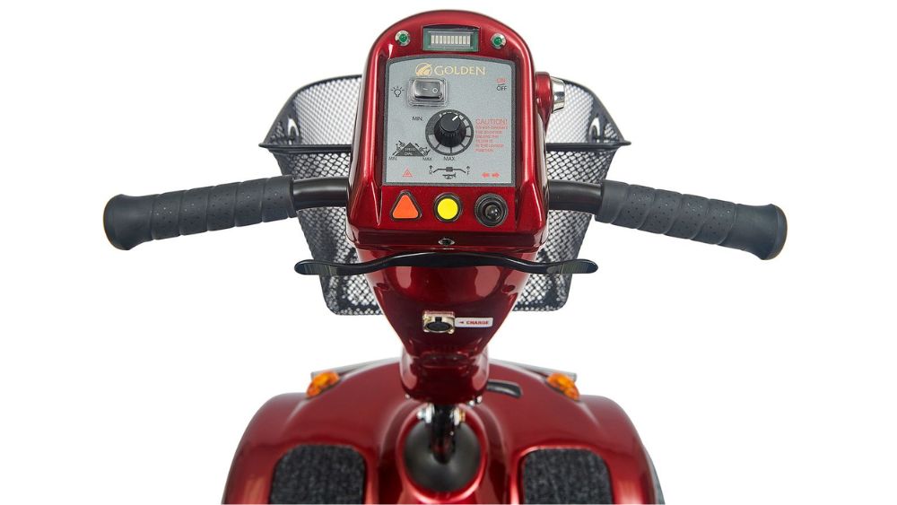 Front view of the Avenger 4-Wheel Scooter’s red handlebars and control panel, featuring a basket and clearly labeled switches and display.