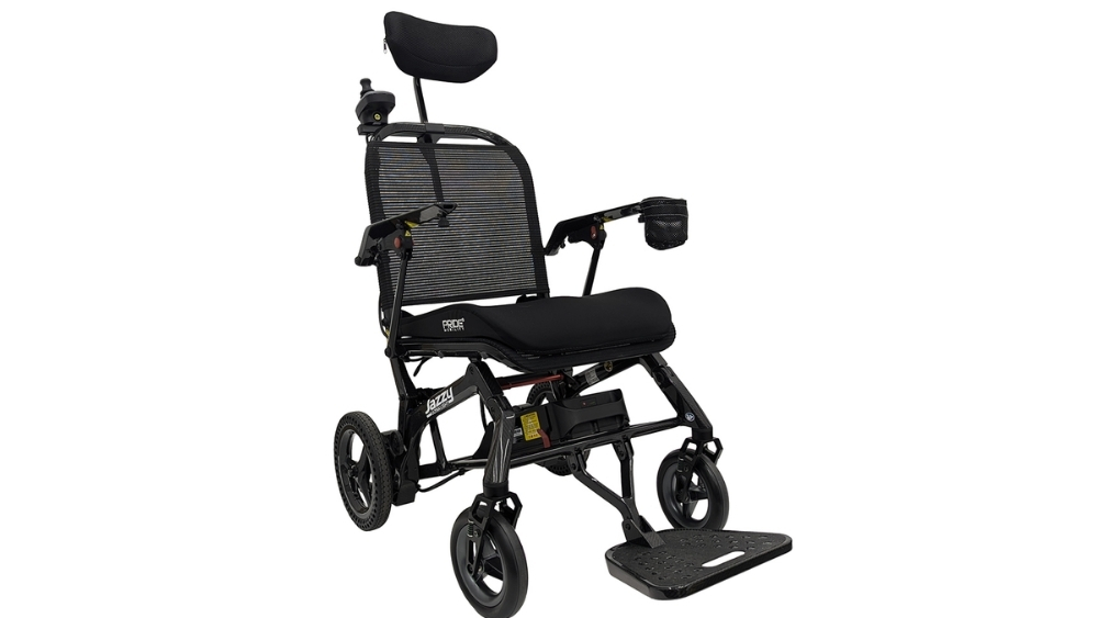 Jazzy® Ultra Light Travel Power Wheelchair with a black frame, mesh backrest, padded seat, headrest, cup holder, and footrest, shown on a plain white background.