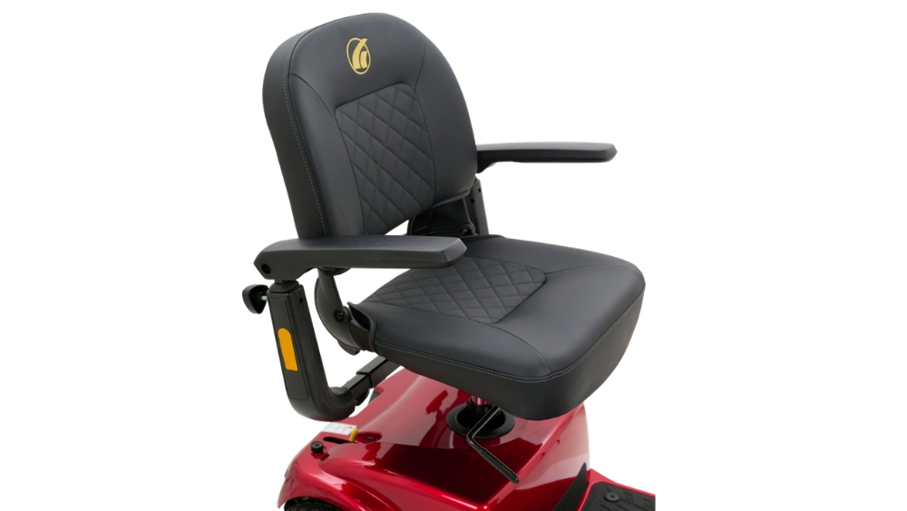 A black cushioned seat with armrests mounted on the base of the Companion Mid-Size 3-Wheel Scooter in red, shown against a white background.