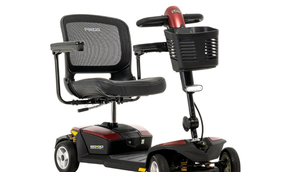 A four-wheel Go Go® Endurance Li mobility scooter featuring a black seat, mesh backrest, armrests, front basket, and red accents, designed for personal transportation.