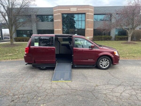 Red Dodge Grand Caravan with Driverge Side Entry Automatic Fold Out conversion