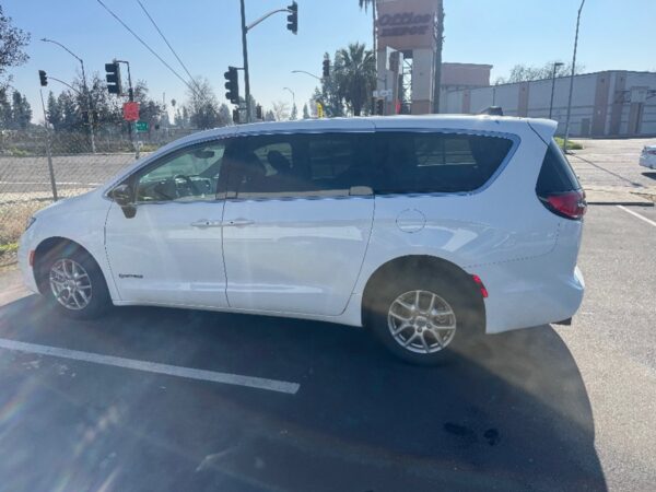 White Chrysler Pacifica with Driverge Side Entry Automatic Fold Out conversion