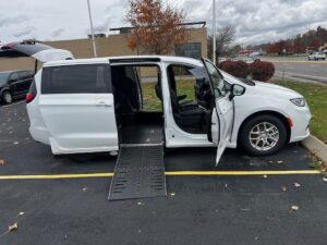 White Chrysler Pacifica with Driverge Side Entry Automatic Fold Out conversion