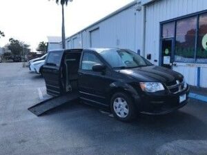 Black Dodge Grand Caravan with BraunAbility Side Entry Automatic Fold Out conversion