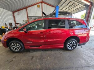 Red Honda Odyssey with BraunAbility Side Entry Automatic In Floor conversion