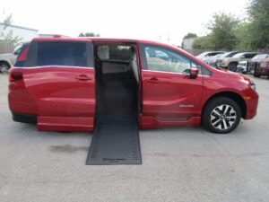Red Honda Odyssey with BraunAbility Side Entry Automatic In Floor conversion