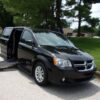 Black Dodge Grand Caravan with Driverge Side Entry Automatic Fold Out conversion