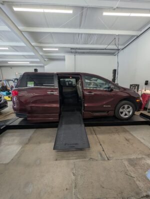 Red Honda Odyssey with BraunAbility Side Entry Automatic In Floor conversion