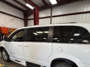 White Dodge Grand Caravan with BraunAbility Side Entry Automatic In Floor conversion