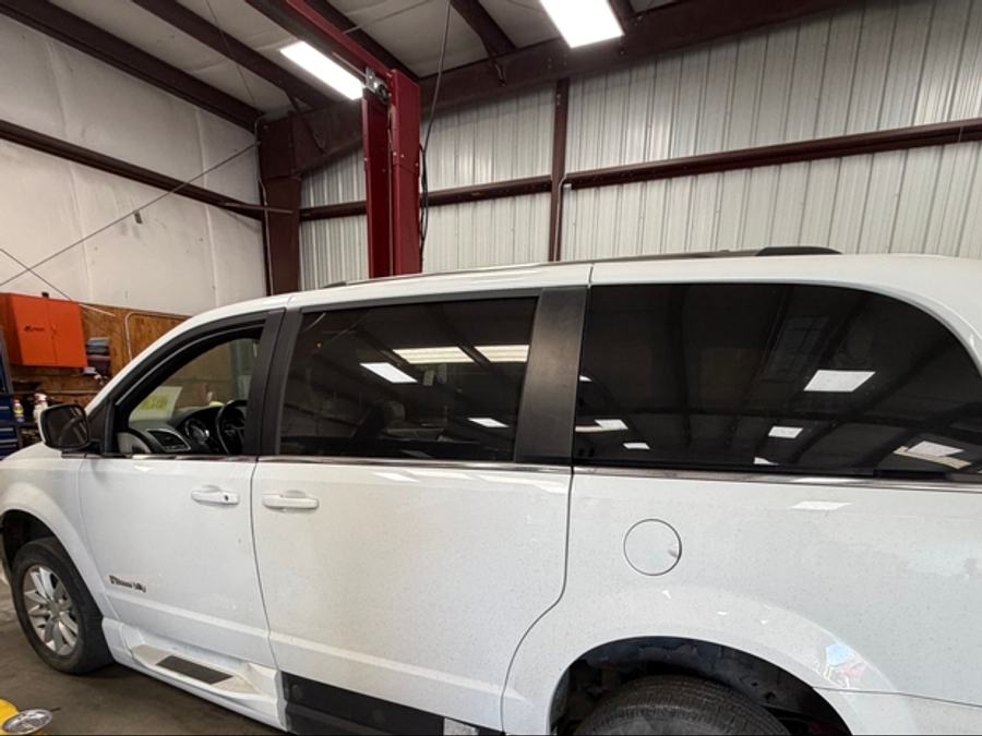 White Dodge Grand Caravan with BraunAbility Side Entry Automatic In Floor conversion
