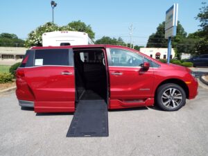 Red Honda Odyssey with BraunAbility Side Entry Automatic In Floor conversion