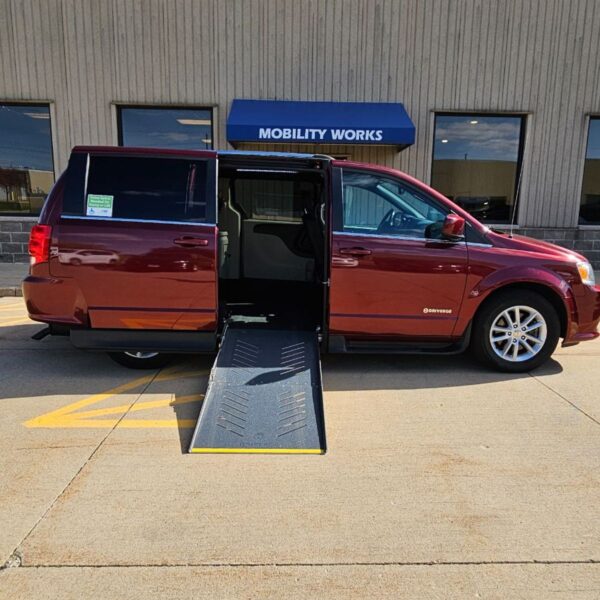 Red Dodge Grand Caravan with Driverge Side Entry Automatic Fold Out conversion