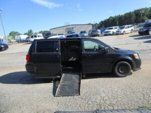 Black Dodge Grand Caravan with Adaptive Vans Side Entry Automatic Fold Out conversion