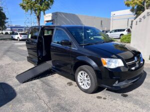 Black Dodge Grand Caravan with Adaptive Vans Side Entry Automatic Fold Out conversion