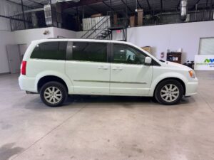 White Chrysler Town and Country with Adaptive Vans Side Entry Automatic Fold Out conversion