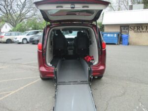 Red Chrysler Voyager with Driverge Rear Entry Manual Fold Out conversion