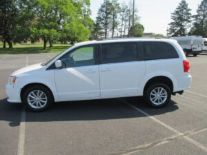 White Dodge Grand Caravan with Driverge Rear Entry Manual Fold Out conversion