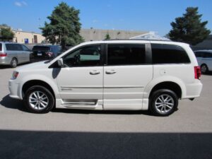 White Dodge Grand Caravan with BraunAbility Side Entry Automatic Fold Out conversion