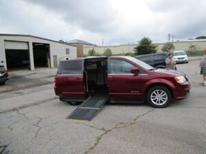 Red Dodge Grand Caravan with Driverge Side Entry Automatic Fold Out conversion
