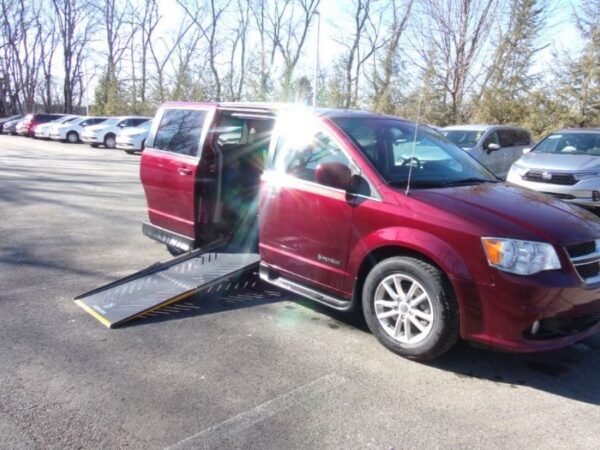 Red Dodge Grand Caravan with Driverge Side Entry Automatic Fold Out conversion