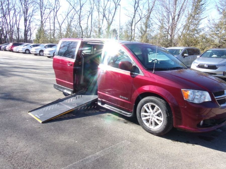 Red Dodge Grand Caravan with Driverge Side Entry Automatic Fold Out conversion