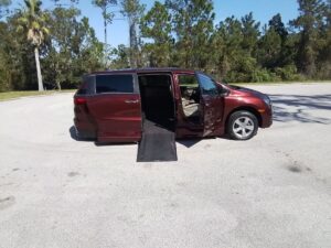 Red Honda Odyssey with BraunAbility Side Entry Automatic In Floor conversion