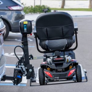 The Harmar Universal Scooter Lift (AL100) securely holds a mobility scooter on the back of a parked car in an outdoor parking lot.