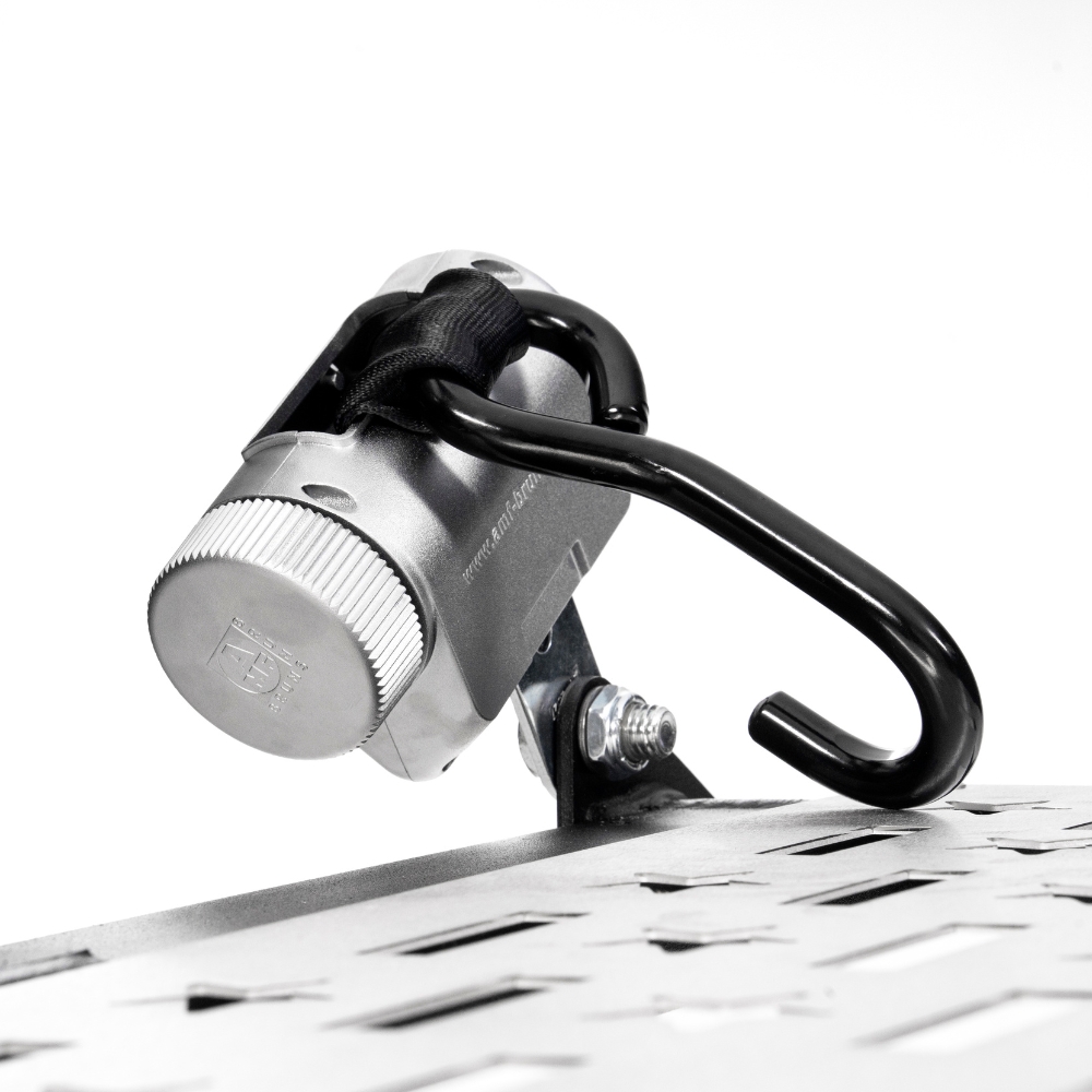 A Harmar Fusion Lift (AL300-MW) metal combination lock with a black hook is affixed to a perforated metal surface, secured by a bolt against a white background.