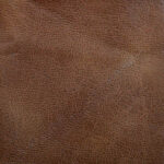 Close-up view of the Dione Lift Chair’s brown leather surface highlighting its natural grain and texture.