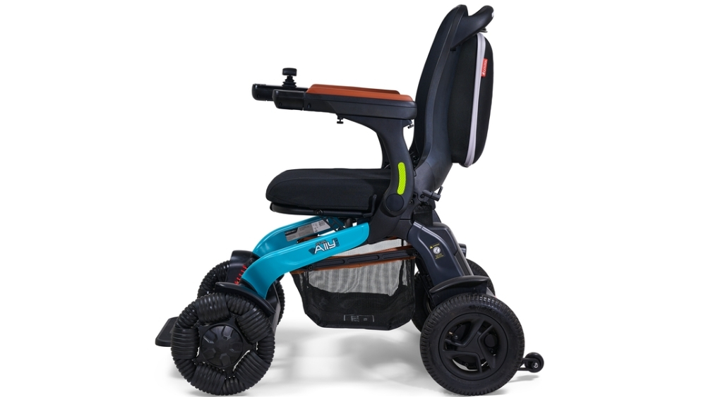 The Ally Pro Power Wheelchair showcases a contemporary design with a blue frame, black seat and backrest, joystick control, four wheels, and a convenient storage basket underneath.