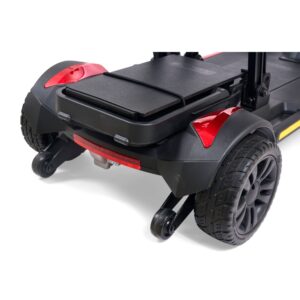 Close-up of the Buzzaround CarryOn 4-Wheel Scooter's rear wheels and base storage compartment, featuring black tires, red reflectors, and anti-tip wheels.