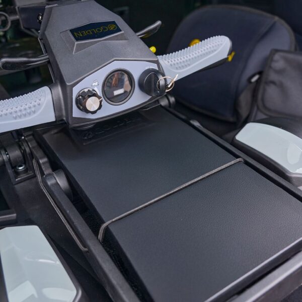 Close-up of a black and gray Buzzaround CarryOn HD 4-Wheel Scooter control panel featuring knobs, a key, and a padded seat visible in the background.